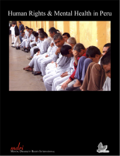 a line of men sitting up against a wall